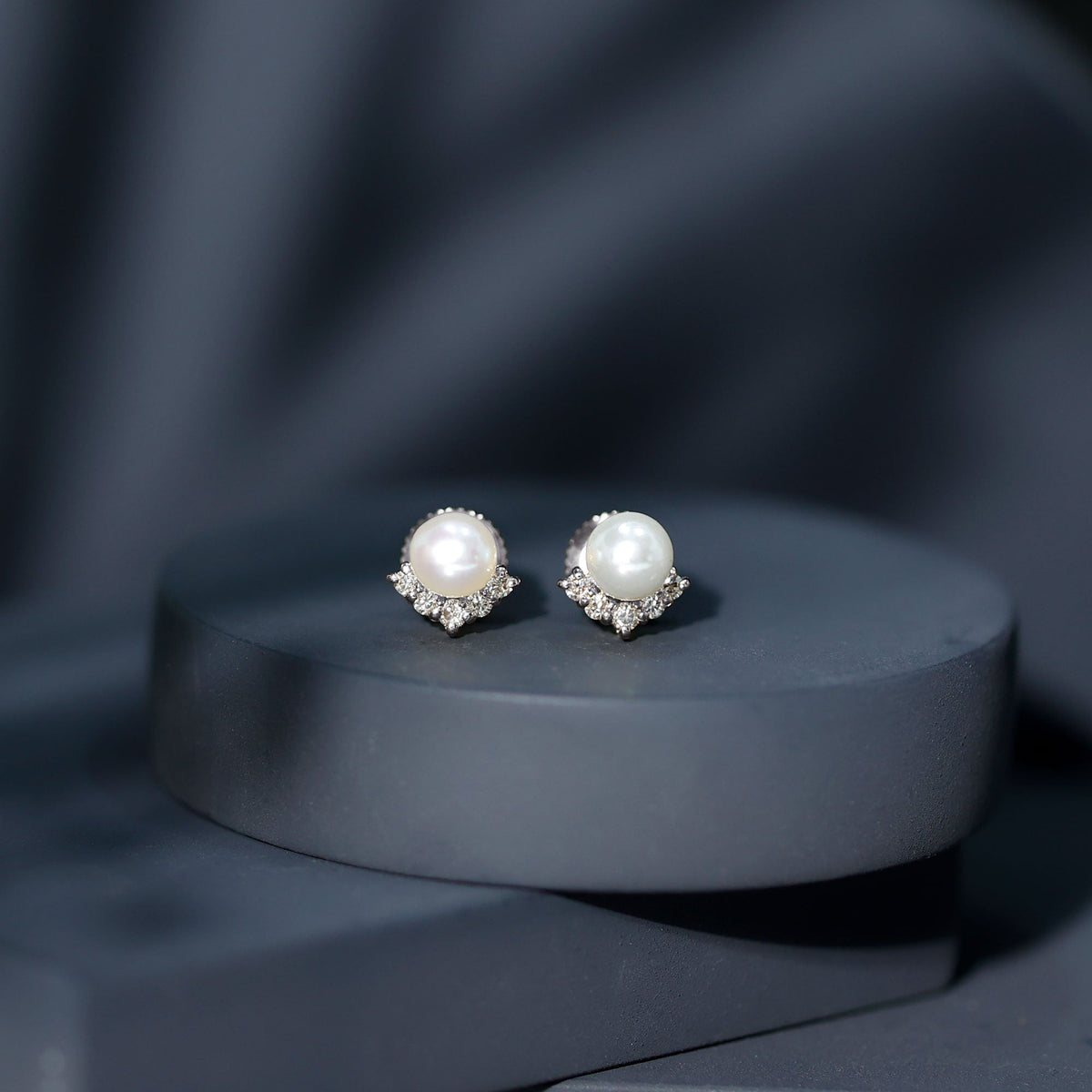 Rosec Jewels modern stud earrings featuring freshwater pearl and diamond accents, showcasing elegant jewelry craftsmanship.