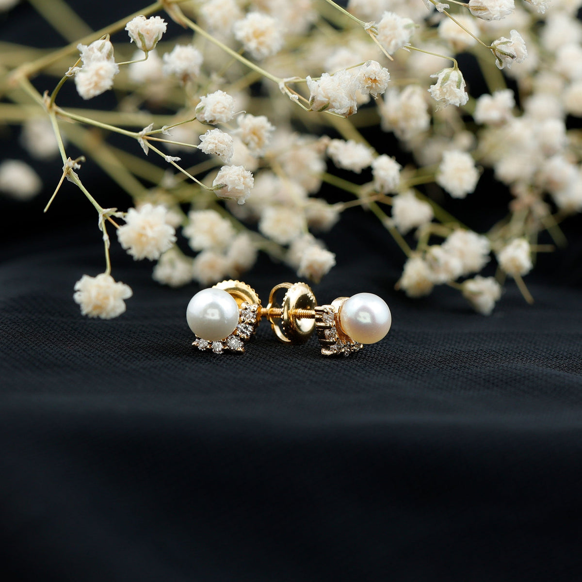 Rosec Jewels modern stud earrings featuring freshwater pearl and diamond accents, close-up view of elegant jewelry design.