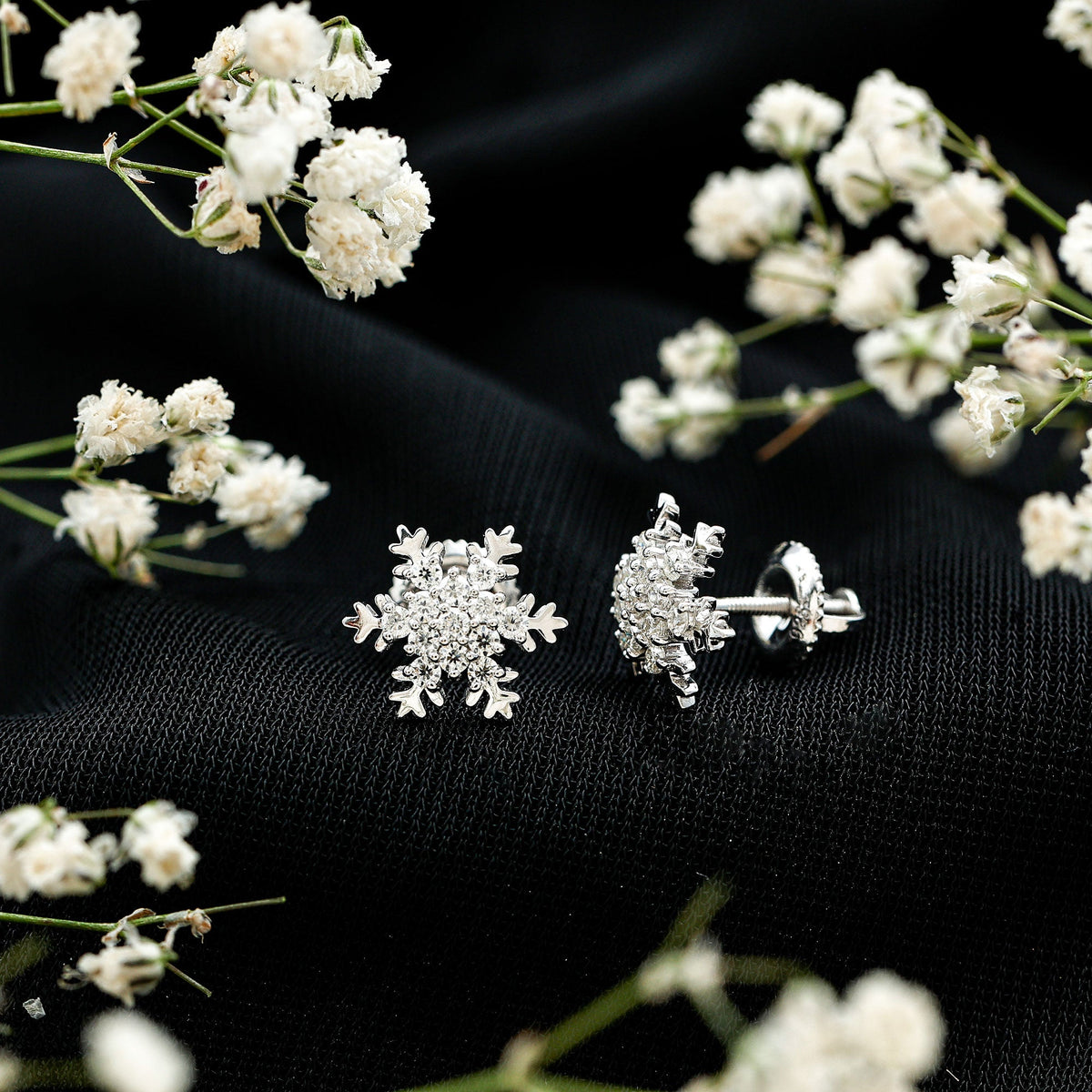 Rosec Jewels certified moissanite winter snowflake stud earrings with sparkling snowflake design and post back closure.