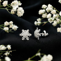 Rosec Jewels certified moissanite winter snowflake stud earrings with sparkling snowflake design and post back closure.