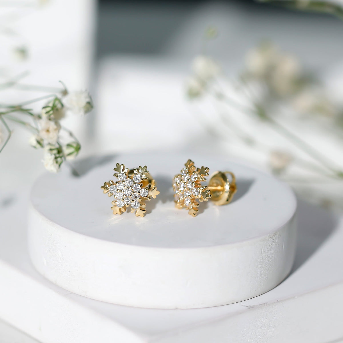 Rosec Jewels certified moissanite winter snowflake stud earrings with sparkling snowflake design and silver-tone setting.