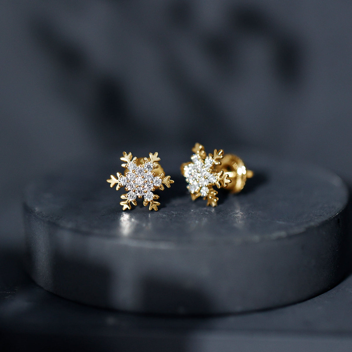 Rosec Jewels certified moissanite snowflake stud earrings with intricate winter-inspired design and sparkling gemstone accents.