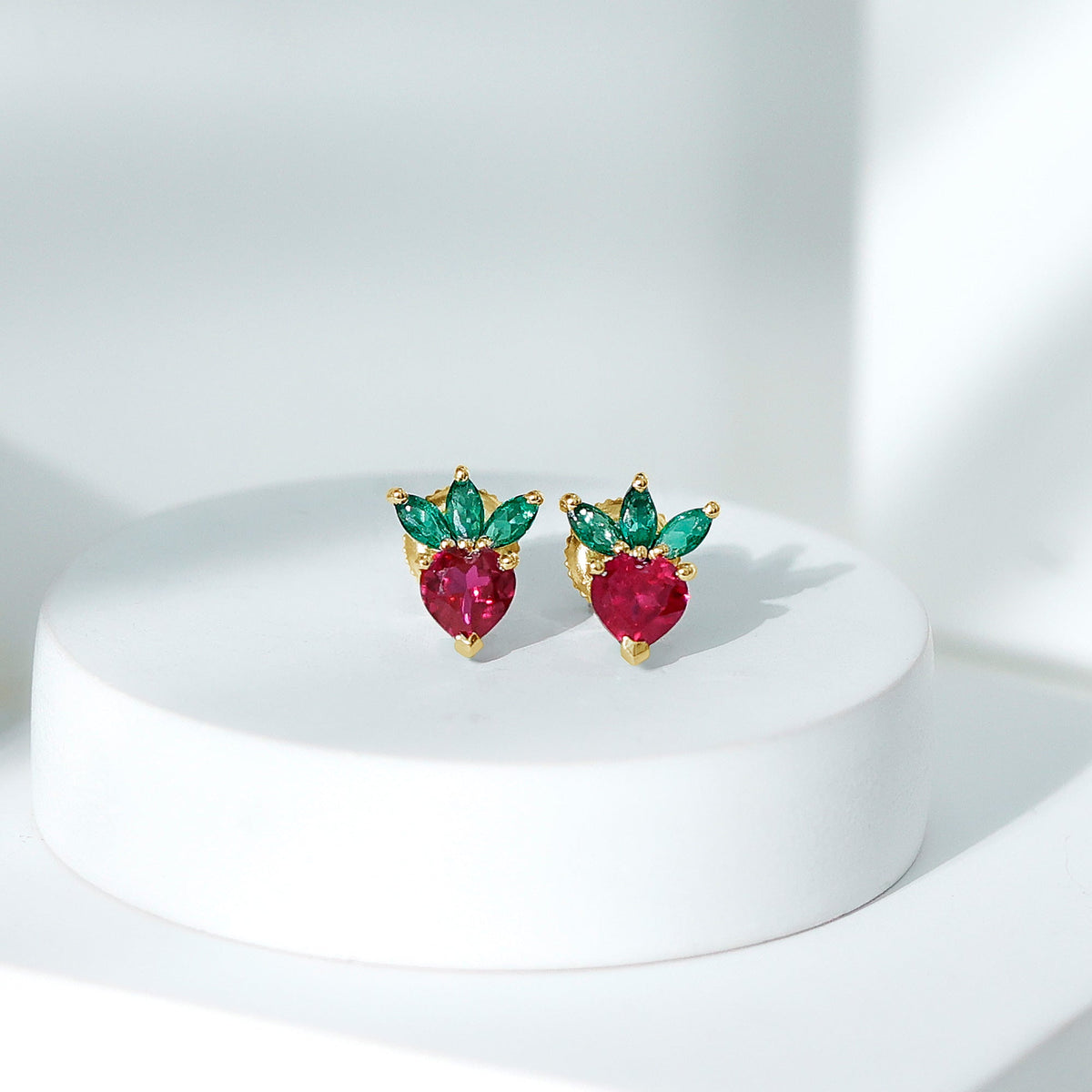 Rosec Jewels strawberry earrings featuring lab-grown rubies and emeralds, showcasing vibrant gemstones and delicate design.