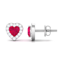 Heart-shaped ruby stud earrings with diamond halo from Rosec Jewels, featuring sparkling gemstones and elegant design.