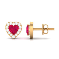 Heart-shaped ruby stud earrings with diamond halo from Rosec Jewels, featuring vibrant red rubies and sparkling diamond accents.