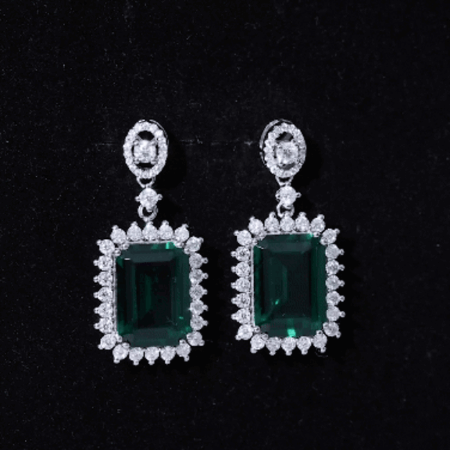 Lab grown 16-carat emerald vintage bridal earrings in silver, featuring intricate detailing and classic elegance.