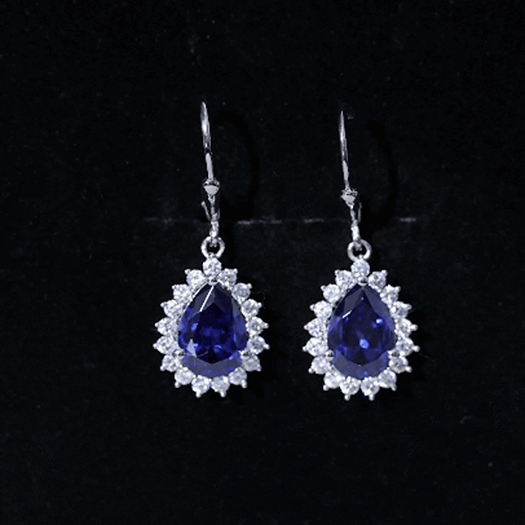 Sterling silver drop earrings with 5 carat lab-grown blue sapphire gemstones, featuring elegant and sparkling jewelry design.
