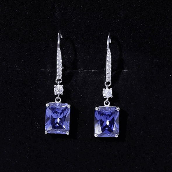 Sterling silver drop earrings with 5.5 carat emerald cut lab-grown blue sapphire gemstones, designed by Rosec Jewels.