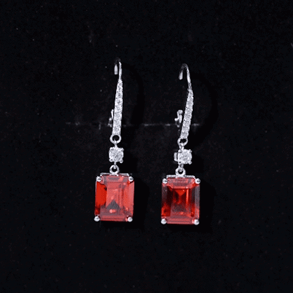 Emerald cut lab-created orange sapphire hoop earrings by Rosec Jewels featuring 5.5 carats of vibrant orange sapphires.