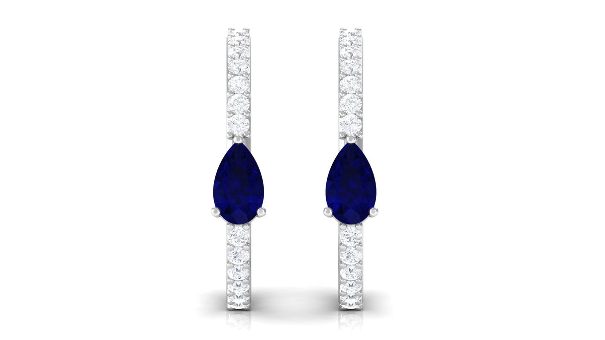 Pear-shaped blue sapphire and diamond hoop earrings by Rosec Jewels with intricate detailing and sparkling gemstones.