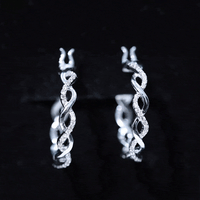 Rosec Jewels braided hoop earrings with sparkling certified moissanite, showcasing intricate design and shimmering stones.