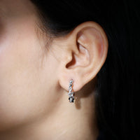 Rosec Jewels braided hoop earrings with sparkling certified moissanite stones, showcasing intricate design and elegant craftsmanship.
