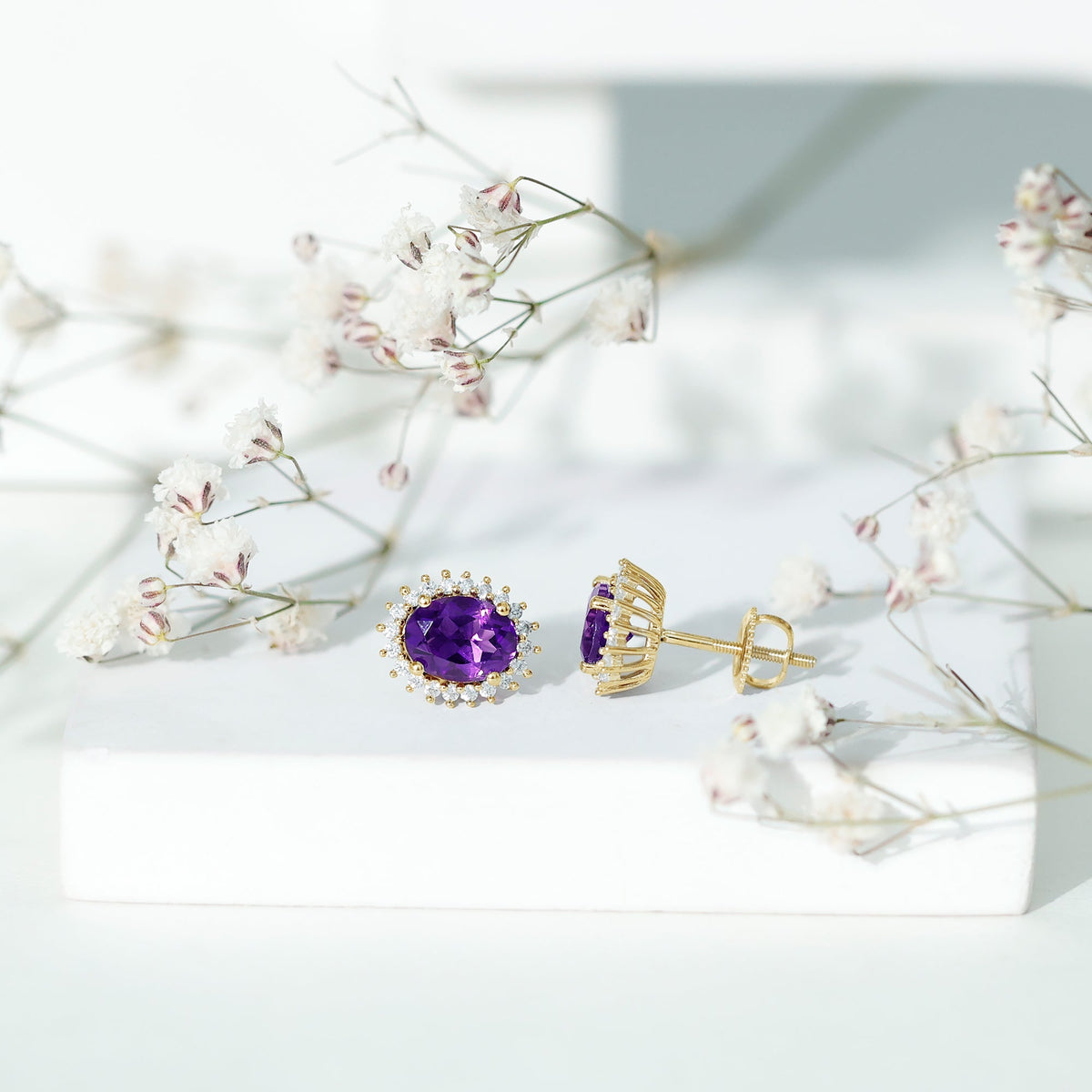 Rosec Jewels classic oval amethyst stud earrings with a sparkling moissanite halo, showcasing elegant gemstone jewelry.