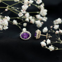 Rosec Jewels classic oval amethyst stud earrings with a moissanite halo setting, featuring sparkling gemstones on a silver backing.