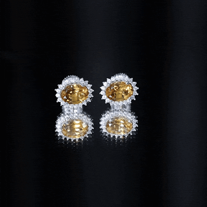 Natural 6x8mm oval citrine stud earrings with halo setting from Rosec Jewels, showcasing sparkling yellow citrine stones.
