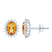 Natural 6x8mm oval citrine stud earrings with halo setting from Rosec Jewels, showcasing sparkling yellow gemstone and elegant design.