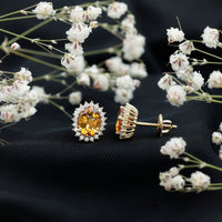 Natural 6x8mm oval citrine stud earrings with halo setting from Rosec Jewels, featuring bright yellow gemstone and elegant design.