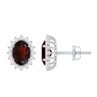 Oval garnet stud earrings with moissanite halo from Rosec Jewels, showcasing vibrant red gemstones and sparkling accents.