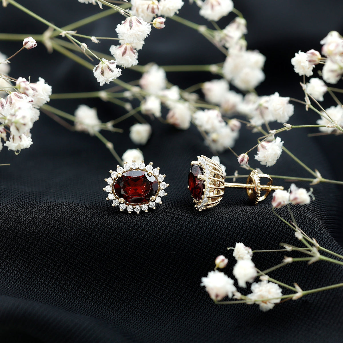 Oval garnet stud earrings with a moissanite halo, featuring a 3-carat center stone and sparkling accents from Rosec Jewels.