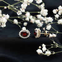 Oval garnet stud earrings with a moissanite halo, featuring a 3-carat center stone and sparkling accents from Rosec Jewels.