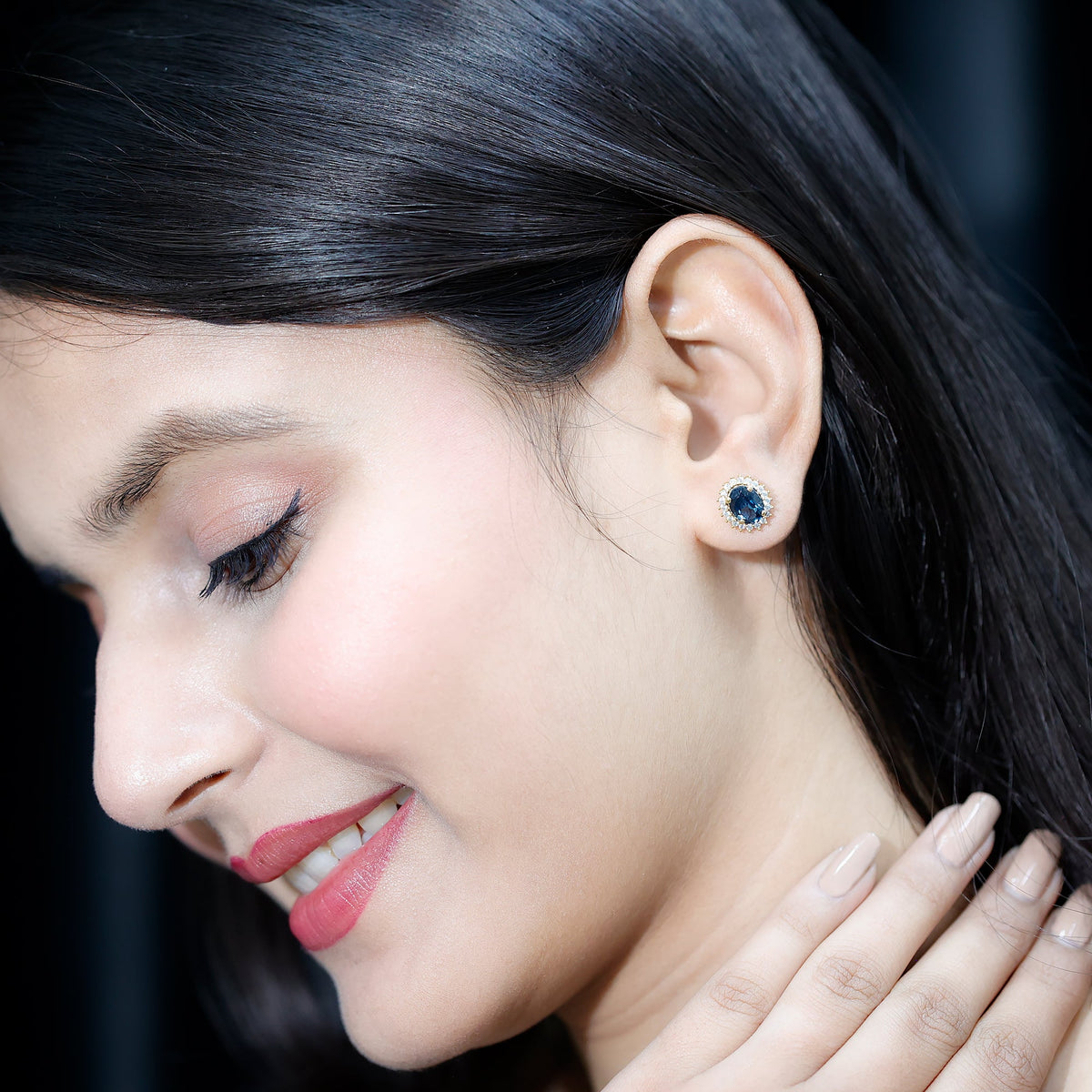 Oval London Blue Topaz stud earrings with moissanite halo, featuring 6x8mm gemstones and rose gold setting.