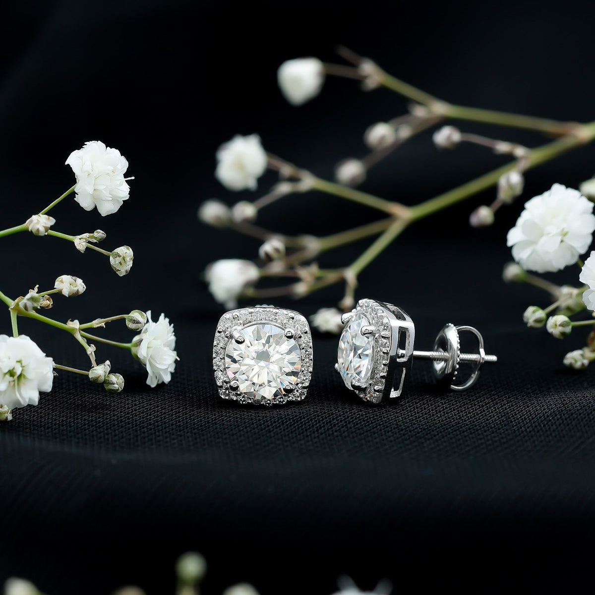 Round cut moissanite halo stud earrings by Rosec Jewels featuring sparkling gemstone accents and a classic earring design.