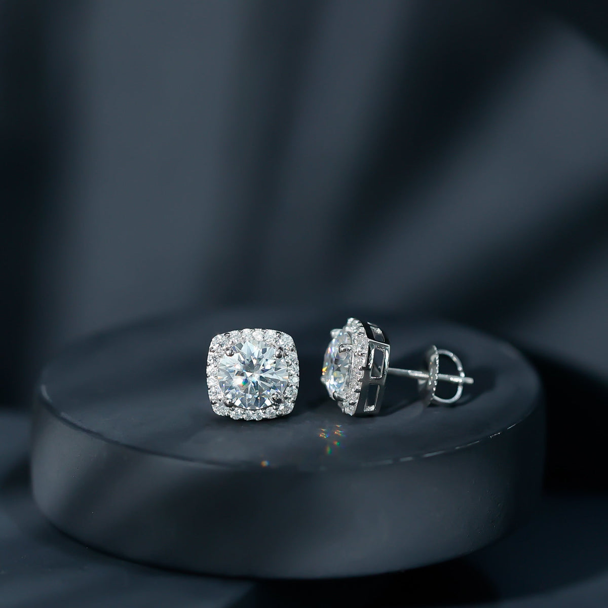 Round cut moissanite halo stud earrings by Rosec Jewels featuring classic design and sparkling gemstone accents.