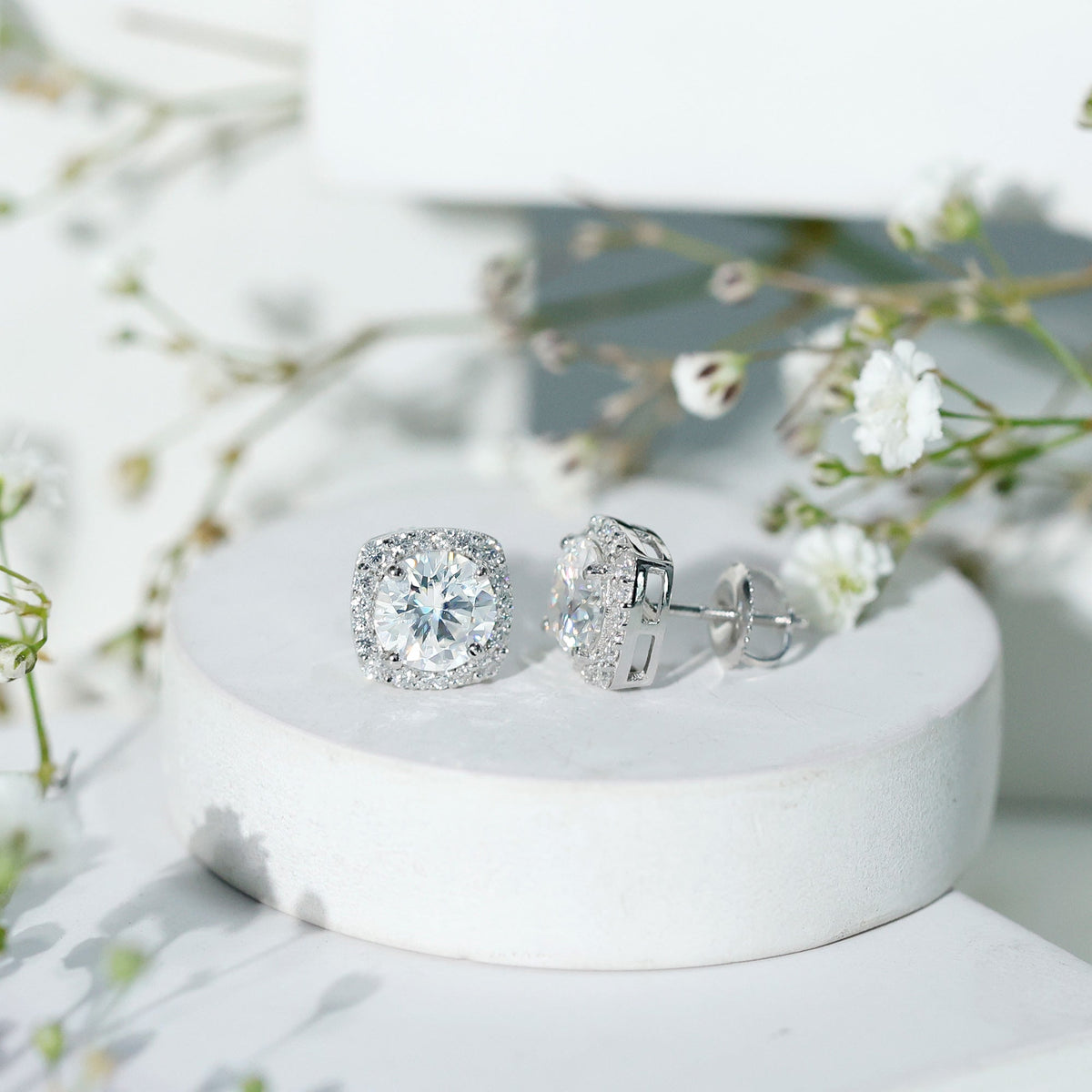Round cut moissanite halo stud earrings by Rosec Jewels featuring sparkling gemstones and a classic, elegant design.