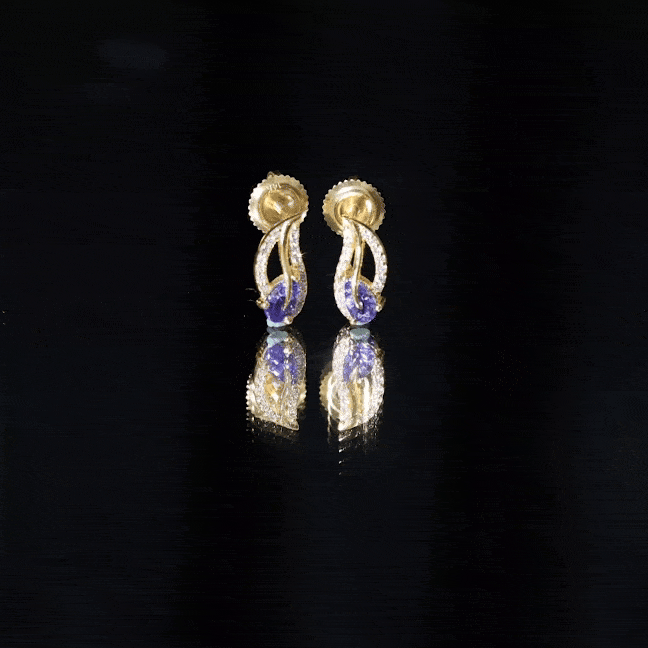 Pear-shaped Tanzanite and diamond leaf stud earrings by Rosec Jewels, featuring vibrant blue gemstones and intricate leaf design.