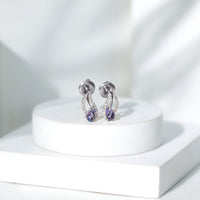 Pear-shaped Tanzanite and diamond leaf stud earrings by Rosec Jewels, featuring elegant gemstone and diamond accents.
