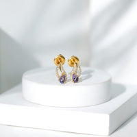 Pear-shaped tanzanite and diamond leaf stud earrings featuring elegant gemstone settings by Rosec Jewels.
