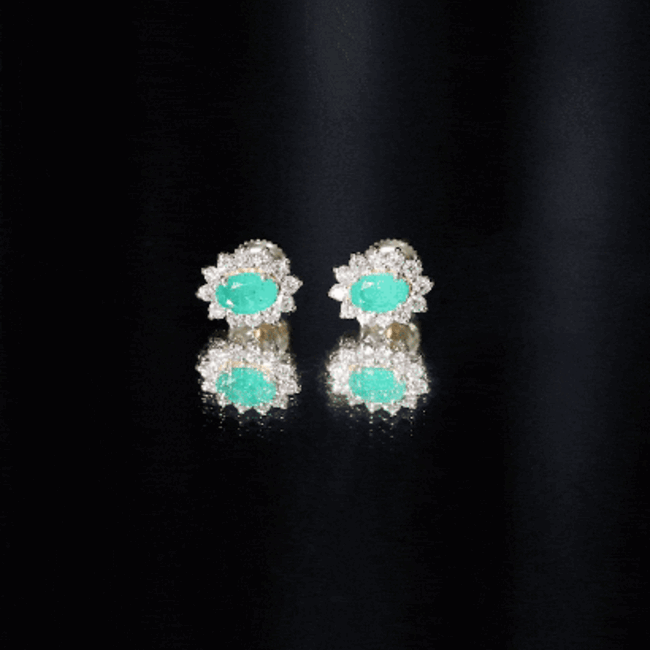 Natural 0.8 carat oval cut emerald and diamond earrings by Rosec Jewels, featuring yellow gold setting and intricate design.