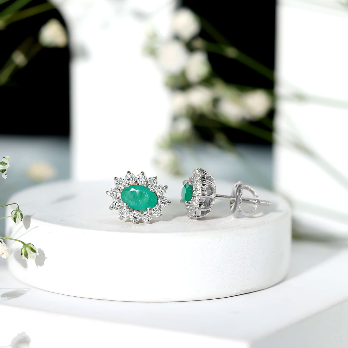 Natural 0.8 carat oval cut emerald and diamond earrings by Rosec Jewels, showcasing elegant gemstone and sparkle details.