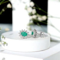 Natural 0.8 carat oval cut emerald and diamond earrings by Rosec Jewels, showcasing elegant gemstone and sparkle details.
