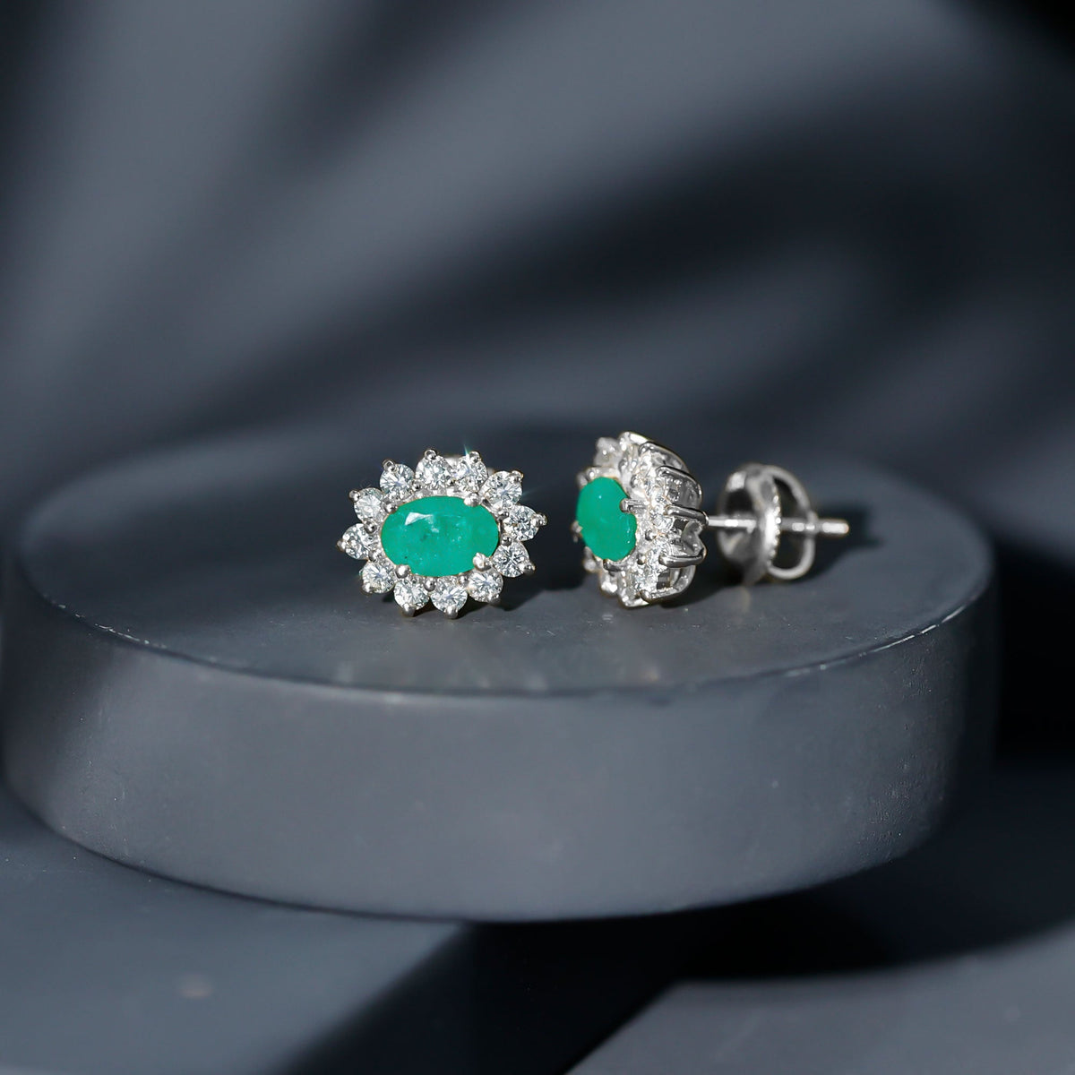 Oval cut emerald and diamond earrings from Rosec Jewels, featuring natural 0.8 carat gemstones and elegant jewelry design.