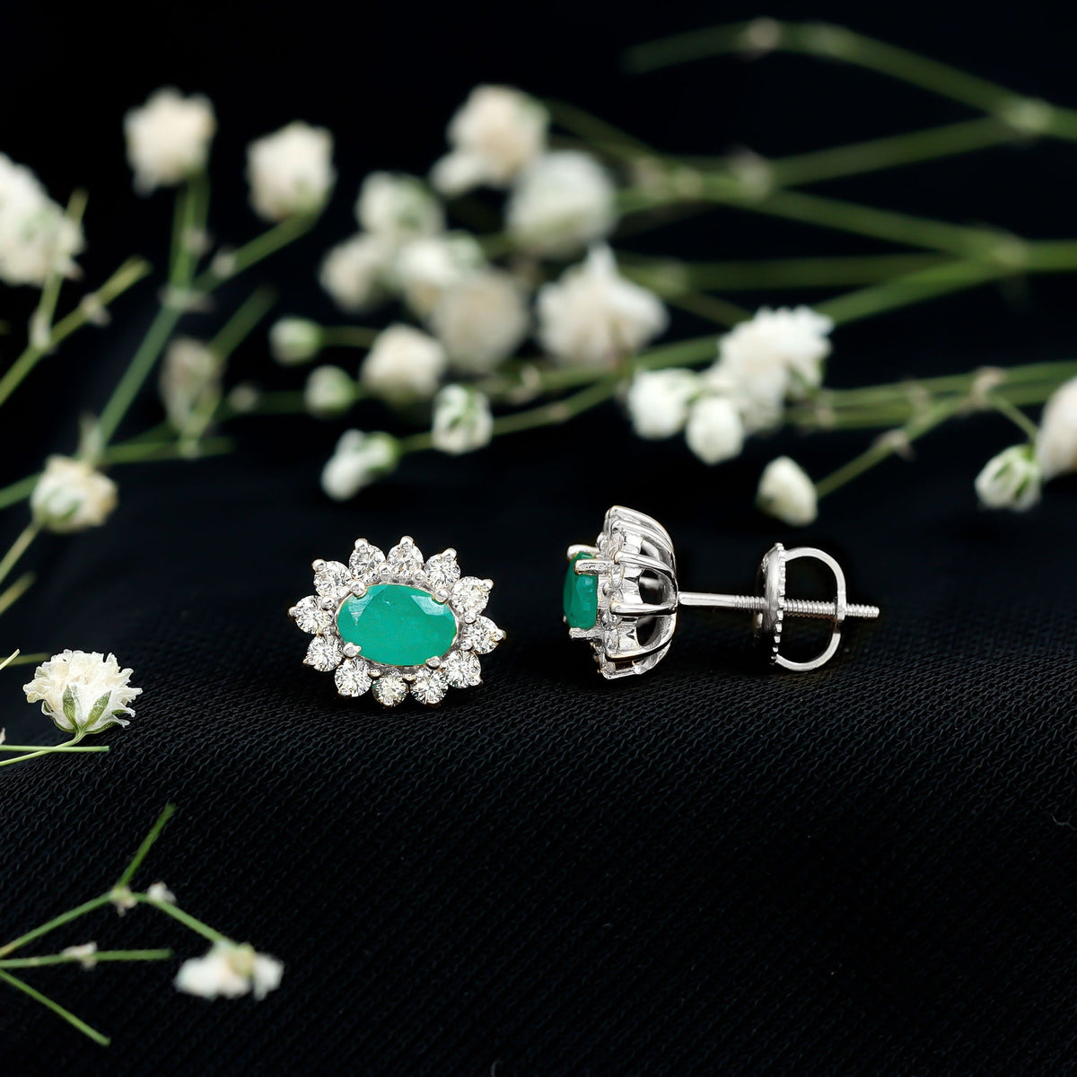 Oval cut emerald and diamond earrings by Rosec Jewels featuring 0.8 carats, set in elegant earring design.