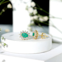 Natural 0.8 carat oval cut emerald and diamond earrings by Rosec Jewels featuring elegant gemstone and sparkle settings.