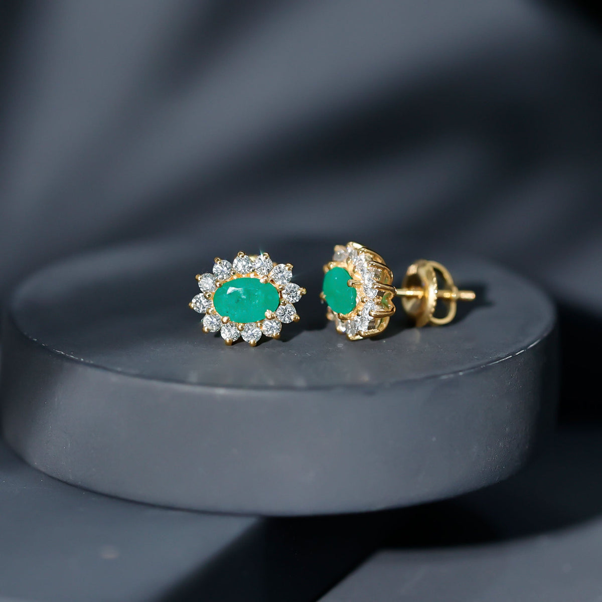 Oval cut emerald and diamond earrings by Rosec Jewels featuring natural 0.8 carat stones in elegant earring design.