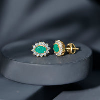Oval cut emerald and diamond earrings by Rosec Jewels featuring natural 0.8 carat stones in elegant earring design.