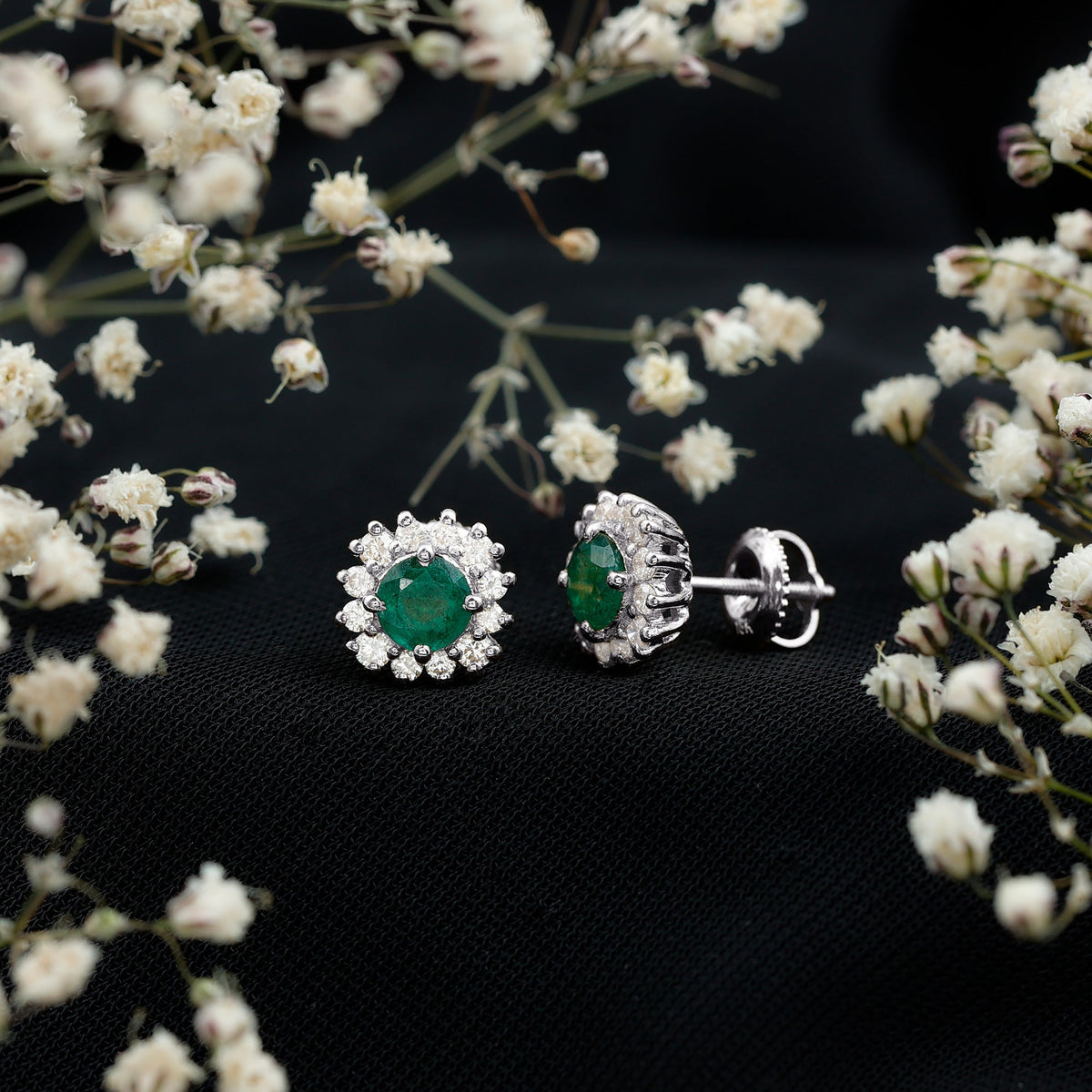 Rosec Jewels classic emerald stud earrings with diamond halo, showcasing sparkling green emeralds and shimmering diamond accents.