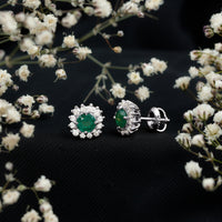 Rosec Jewels classic emerald stud earrings with diamond halo, showcasing sparkling green emeralds and shimmering diamond accents.