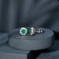 Rosec Jewels classic emerald stud earrings with diamond halo, featuring sparkling green gemstones and elegant metallic setting
