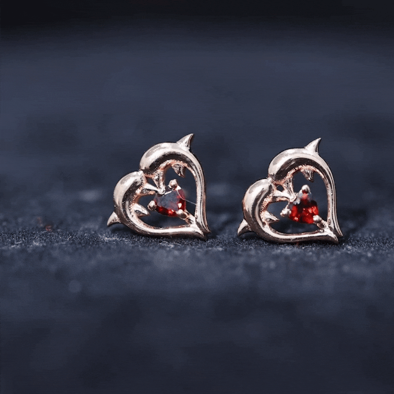 Heart-shaped garnet dolphin stud earrings by Rosec Jewels featuring yellow accents, showcasing detailed dolphin and heart designs.