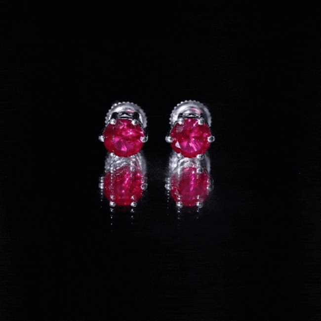 Rosec Jewels 2.7 Carat round cut solitaire lab-created ruby stud earrings on a yellow background.
