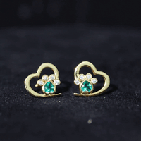 Lab-created emerald and moissanite heart paw stud earrings with yellow accents, featuring sparkling gemstones and delicate design.