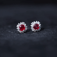Genuine ruby stud earrings with diamond halo from Rosec Jewels, featuring vibrant red rubies and sparkling diamond accents.