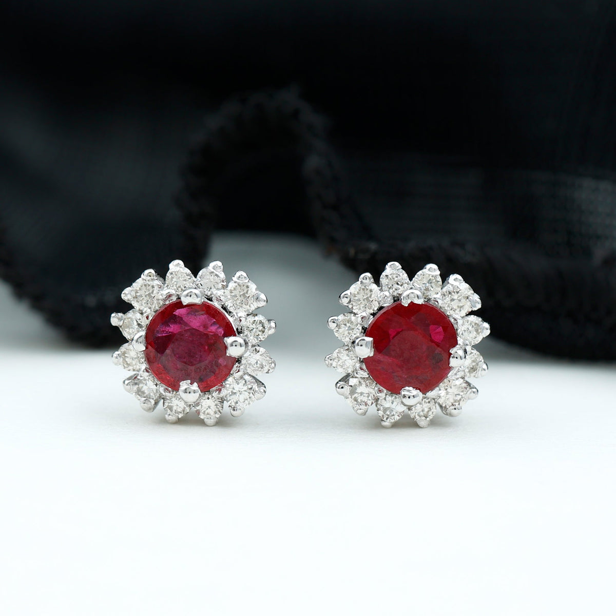 Genuine ruby stud earrings with diamond halo featuring Rosec Jewels, showcasing the sparkling ruby and elegant diamond accents.