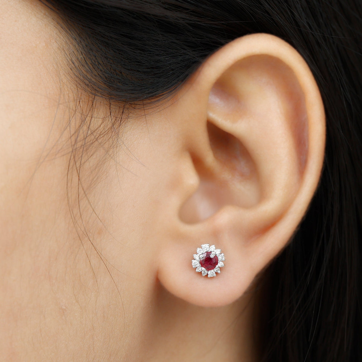 Genuine ruby stud earrings with diamond halo from Rosec Jewels, featuring vibrant red rubies and sparkling diamond accents.