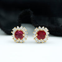 Genuine ruby stud earrings with diamond halo from Rosec Jewels, featuring vibrant red rubies surrounded by sparkling diamonds.