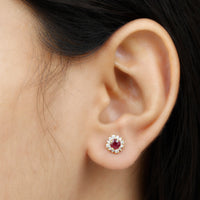 Genuine ruby stud earrings with diamond halo from Rosec Jewels, featuring vibrant red rubies and sparkling diamond accents.